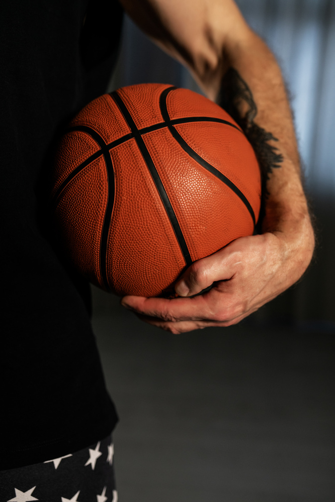 Close-Up Photo of a Person Holding a Basketball